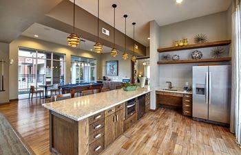 A kitchen with wooden floors and a large island.